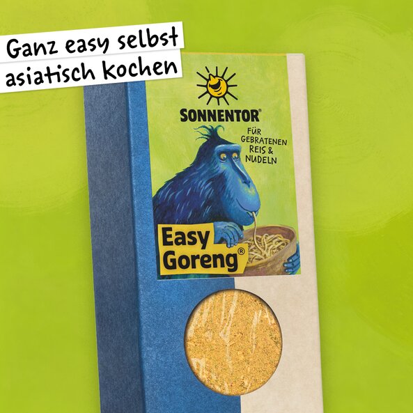 Easy Goreng spice in a pack with a window and illustration with the words: ‘Easy Asian cooking at home’ and a blue monkey eating noodles from a key on a light green background.
