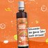 An illustration of a SONNENTOR orange bitter syrup bottle with the text: ‘Tastes like a holiday all year round’ on an orange background.